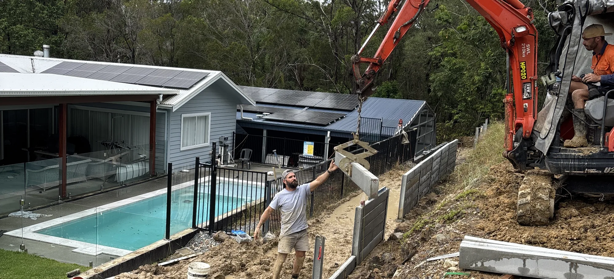 Pro-Form Landscapes building a retaining wall beside a pool