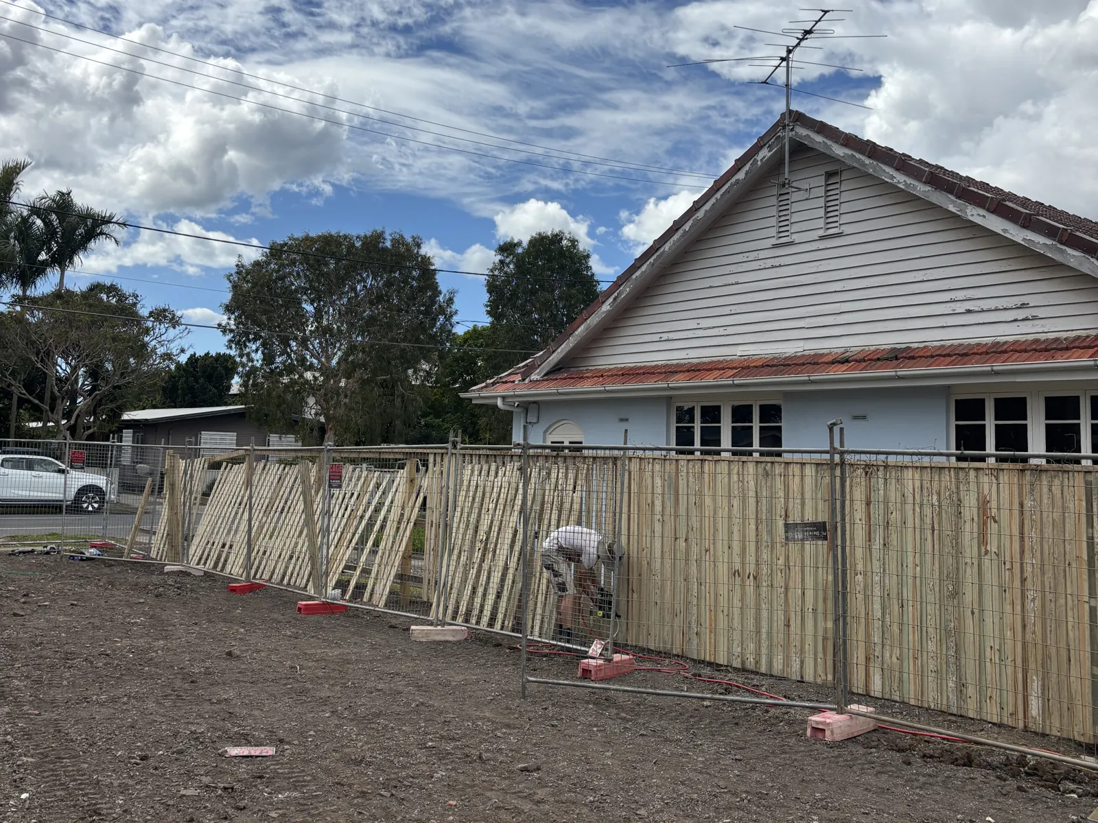 Crew building a paling fence