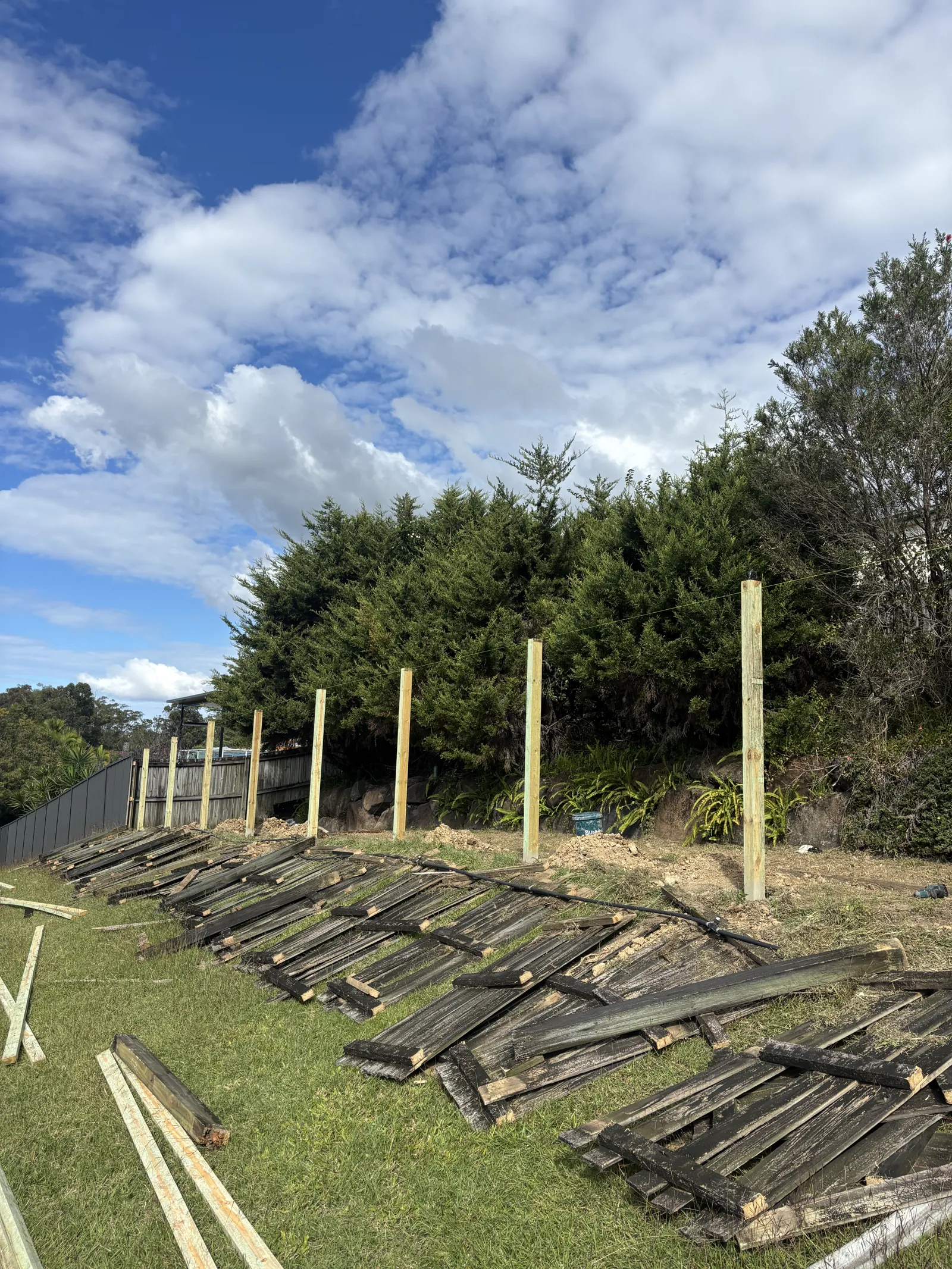 Old timber fence pulled out and stacked ready for removal