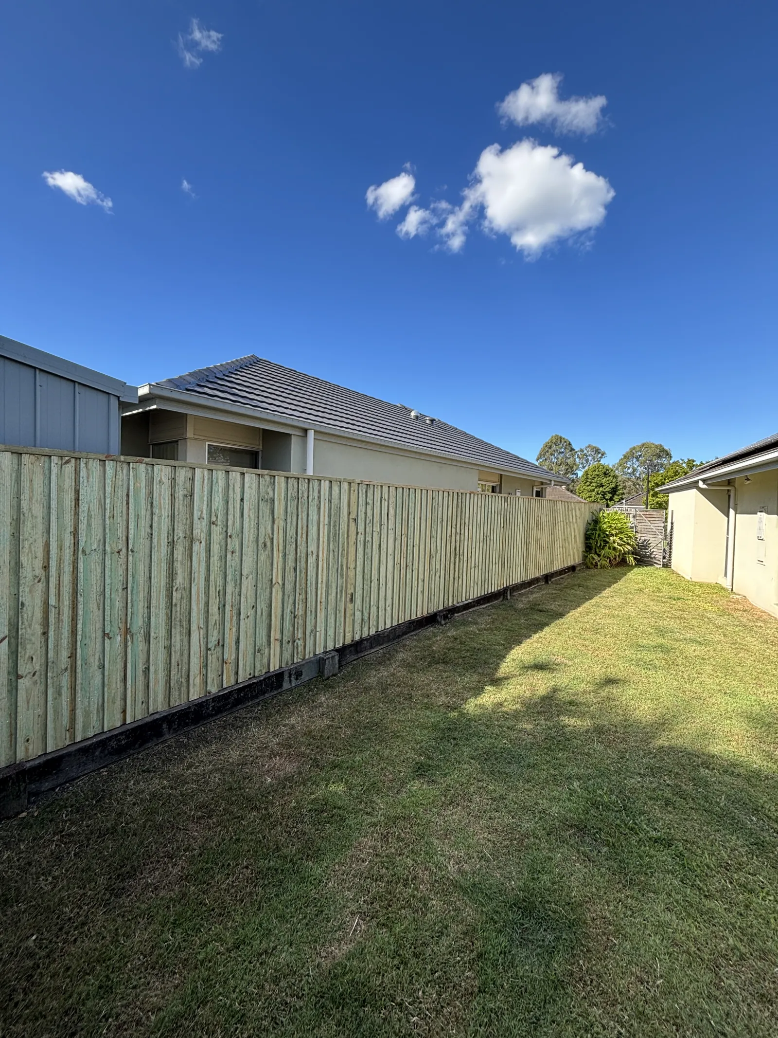 Long timber paling fence along a side boundary