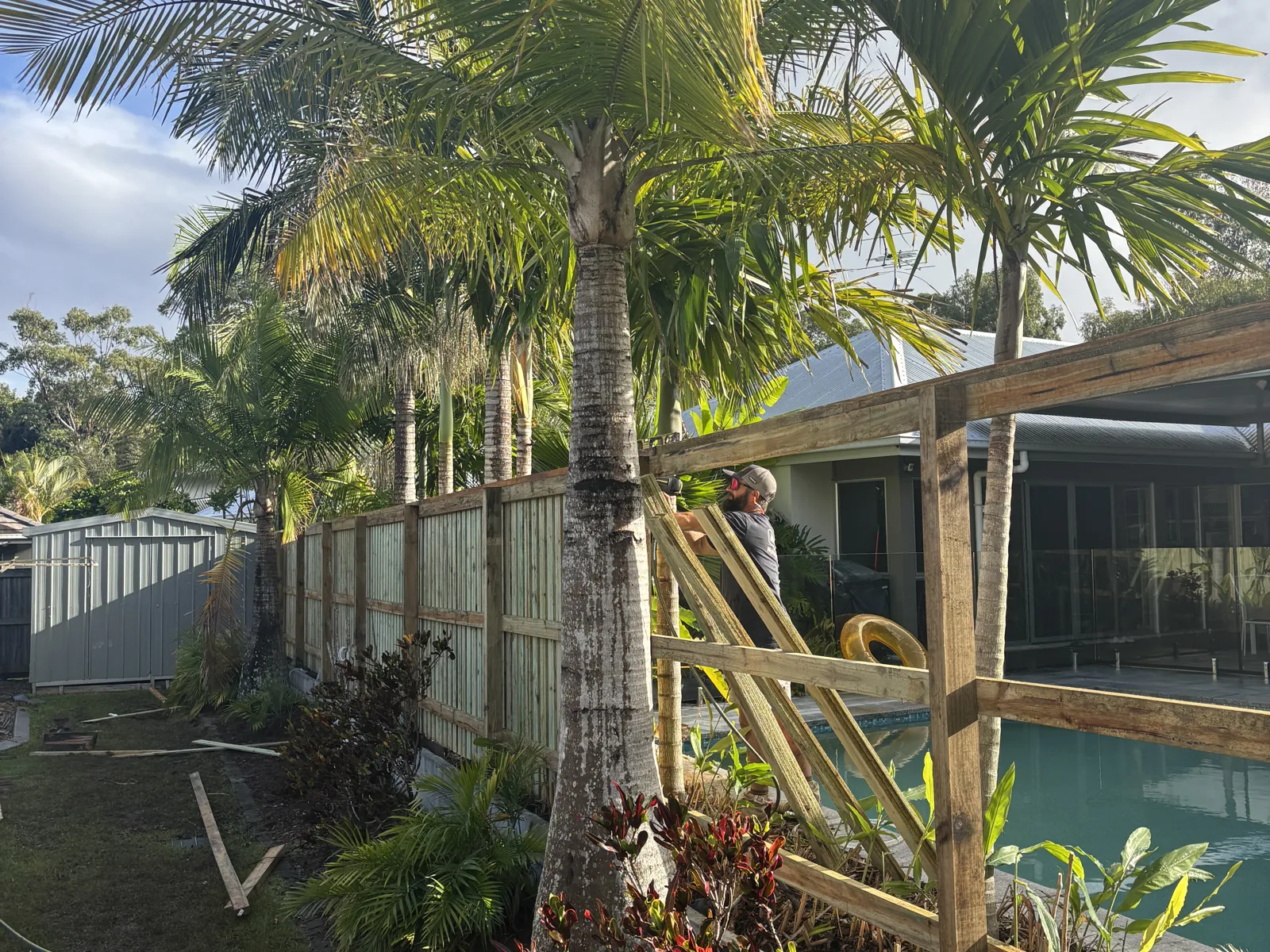 Fence under construction beside a pool