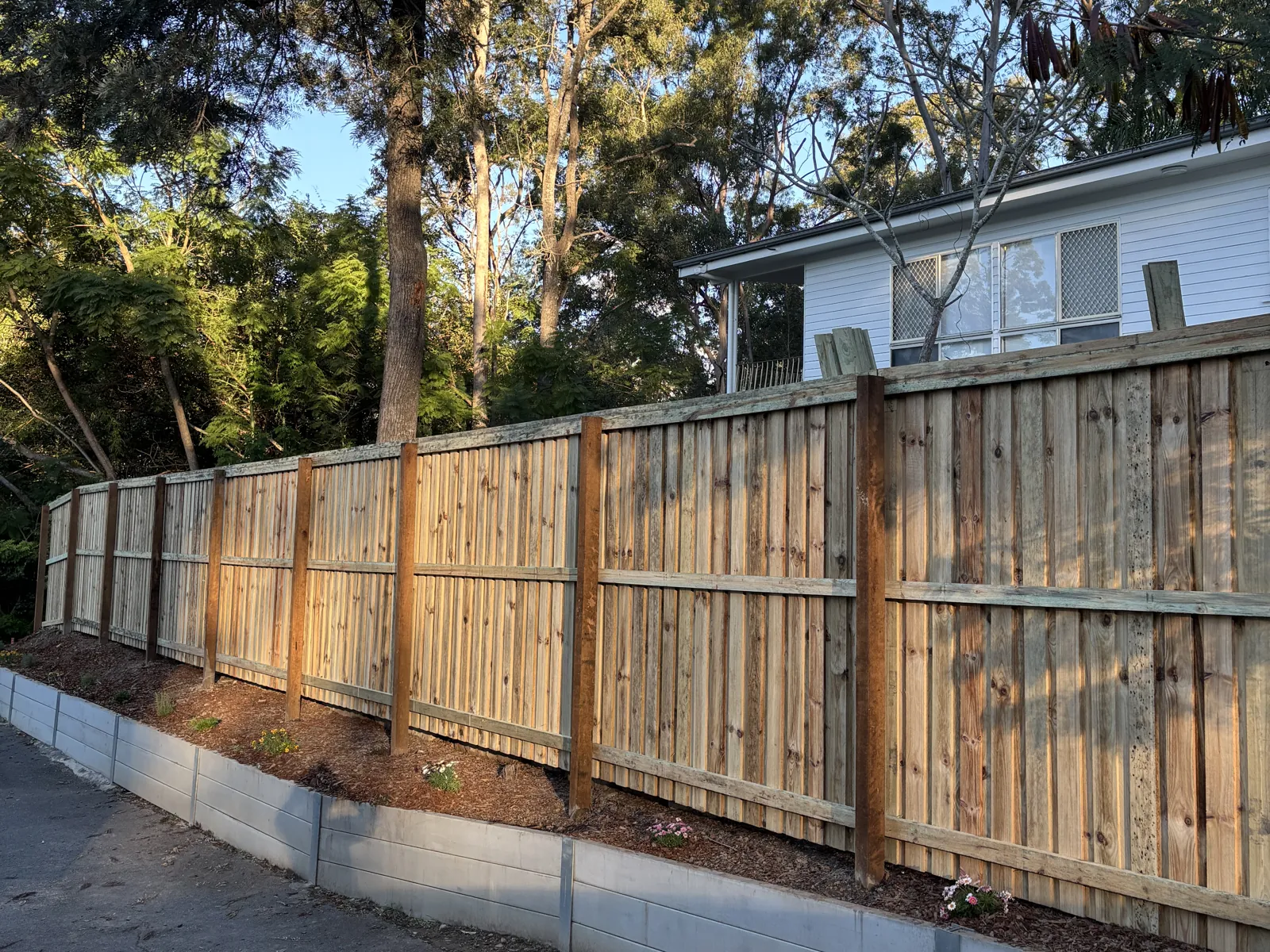Fence on top of a retaining wall