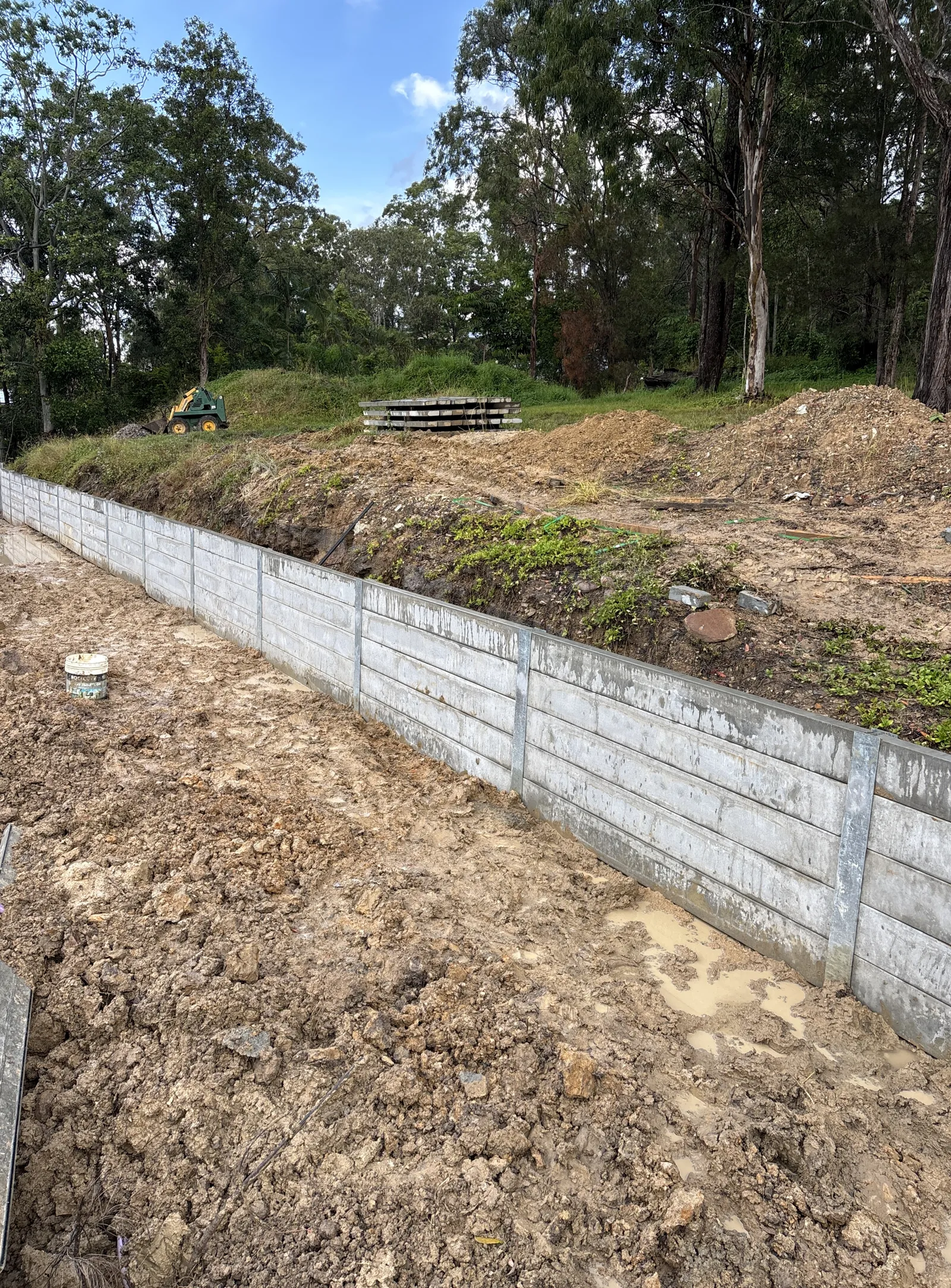 Long concrete sleeper retaining wall on a cut slope
