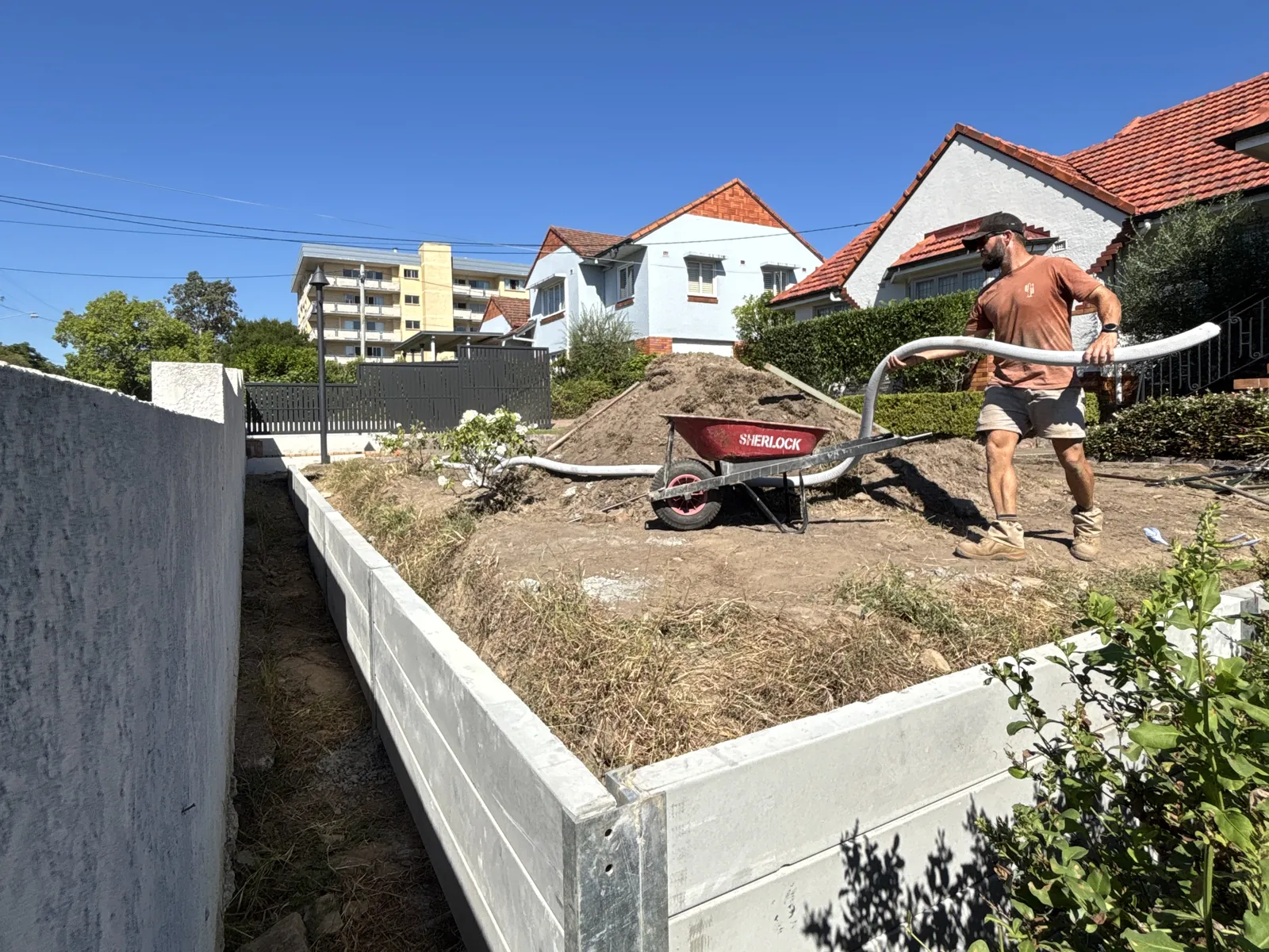 Tall concrete sleeper wall under construction